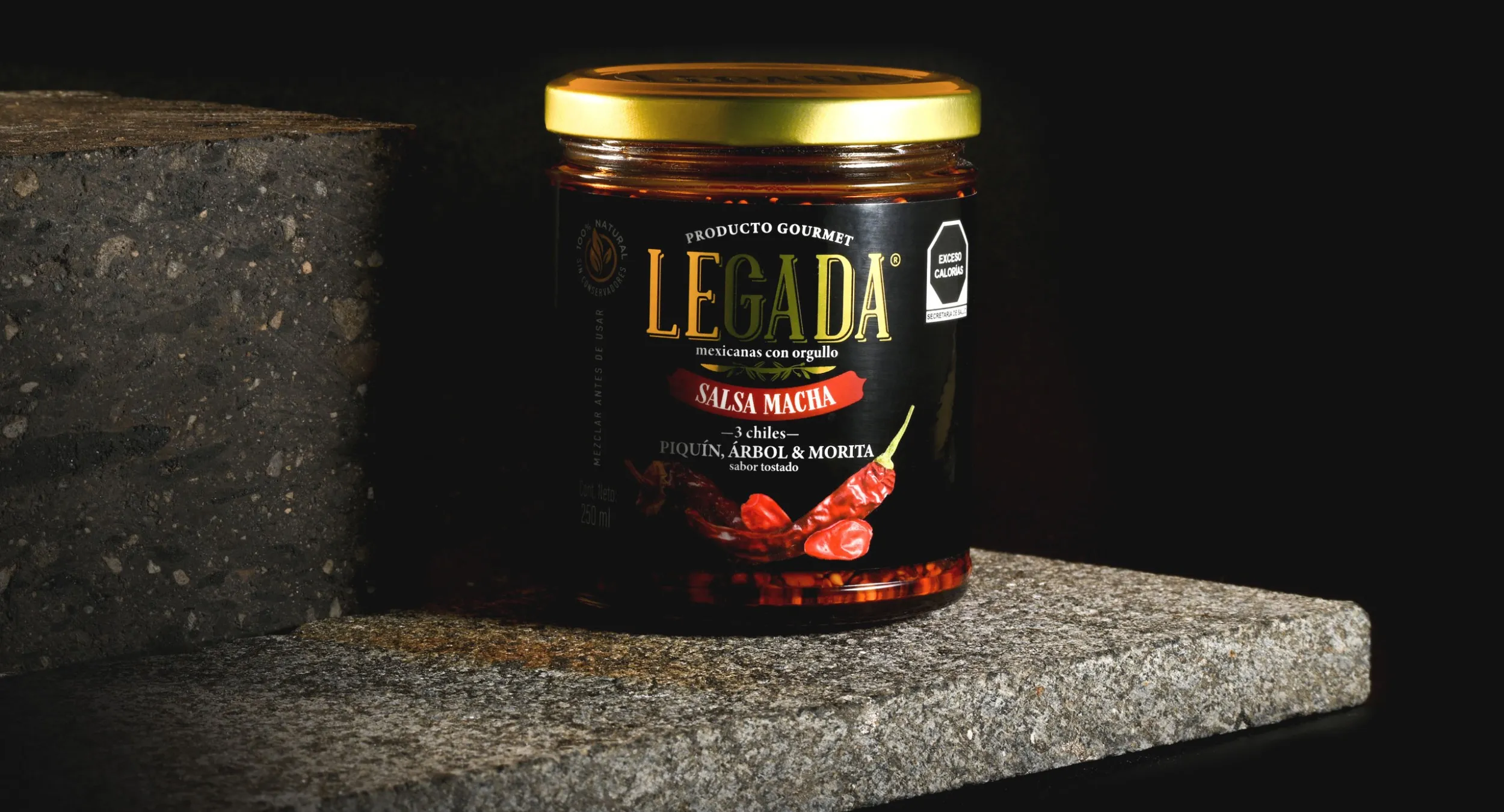 Envase de la salsa macha sobre una mesa de piedra